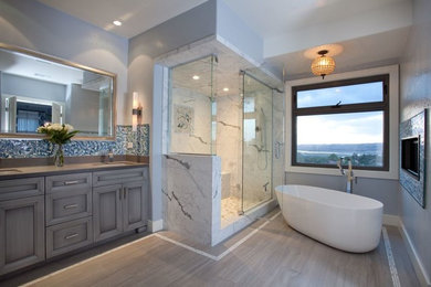 Large trendy master white tile and marble tile porcelain tile and beige floor bathroom photo in San Diego with gray walls, shaker cabinets, a one-piece toilet, an undermount sink, quartz countertops, a hinged shower door and gray cabinets