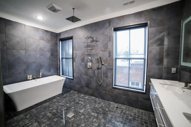 Example of a large minimalist master gray tile and porcelain tile porcelain tile, gray floor and double-sink bathroom design in Richmond with white cabinets, a two-piece toilet, a drop-in sink, white countertops, a floating vanity, quartzite countertops and a niche