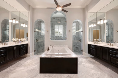 Large trendy master gray tile and porcelain tile porcelain tile bathroom photo in Tampa with a drop-in sink, black cabinets, granite countertops and white walls