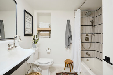 Example of a small minimalist kids' beige tile and ceramic tile ceramic tile, beige floor and double-sink bathroom design in San Diego with black cabinets, a one-piece toilet, white walls, a wall-mount sink, concrete countertops, white countertops, a niche and a floating vanity