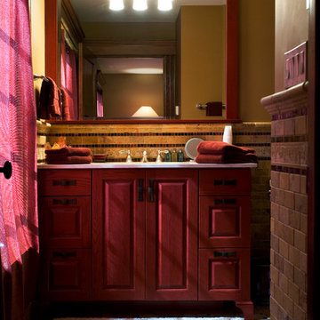 Furniture style painted red sink cabinet with cabinet framed mirror