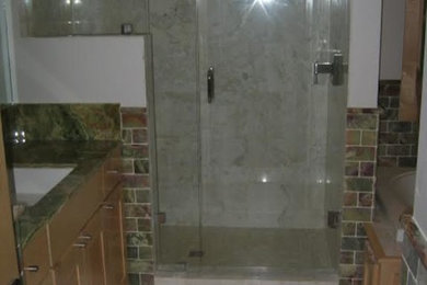 Example of a mid-sized classic 3/4 porcelain tile and multicolored tile marble floor alcove shower design in Other with shaker cabinets, light wood cabinets, white walls, an undermount sink and granite countertops