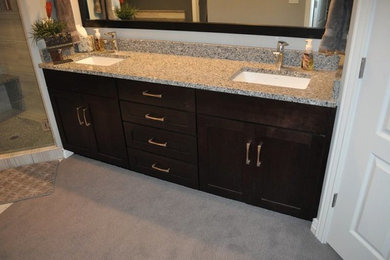 Inspiration for a mid-sized corner shower remodel in Salt Lake City with shaker cabinets, dark wood cabinets, granite countertops and beige walls