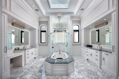 Inspiration for a huge timeless master gray tile and stone tile marble floor and gray floor bathroom remodel in Miami with raised-panel cabinets, white cabinets, gray walls, a drop-in sink, a hinged shower door and marble countertops