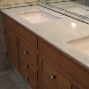 Inspiration for a mid-sized mediterranean master multicolored tile and ceramic tile ceramic tile alcove shower remodel in Boston with a drop-in sink, raised-panel cabinets, medium tone wood cabinets, marble countertops and multicolored walls