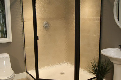 Mid-sized elegant 3/4 beige tile and ceramic tile ceramic tile and beige floor corner shower photo in New Orleans with a one-piece toilet, brown walls, a pedestal sink and a hinged shower door