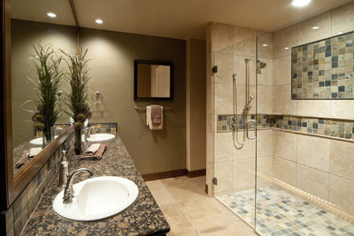 This is an example of a bathroom in Birmingham with granite worktops, a walk-in shower, beige tiles, stone tiles, green walls and ceramic flooring.