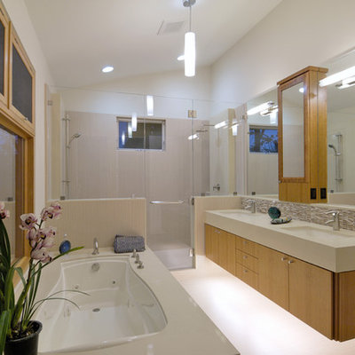 Example of a trendy gray tile alcove shower design in San Francisco with an undermount sink, flat-panel cabinets, medium tone wood cabinets and an undermount tub