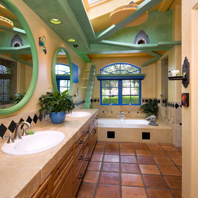 Eclectic beige tile and stone tile terra-cotta tile corner shower photo in Santa Barbara with a drop-in sink, shaker cabinets, medium tone wood cabinets, beige walls and an undermount tub