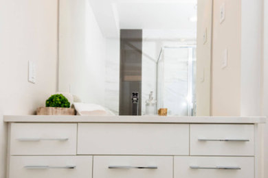 Trendy bathroom photo in Edmonton with white cabinets and quartz countertops