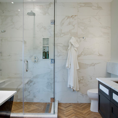 Inspiration for a mid-sized modern master beige tile, white tile and marble tile porcelain tile and brown floor bathroom remodel with shaker cabinets, black cabinets, a one-piece toilet, granite countertops, a hinged shower door, white walls and a trough sink