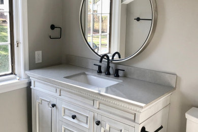 Mid-sized kids' gray tile and porcelain tile porcelain tile and black floor bathroom photo in Cleveland with recessed-panel cabinets, white cabinets, gray walls, quartz countertops, gray countertops and an undermount sink