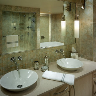 Large trendy master green tile and glass sheet limestone floor bathroom photo in Other with light wood cabinets, a one-piece toilet, a vessel sink, limestone countertops, flat-panel cabinets and green walls