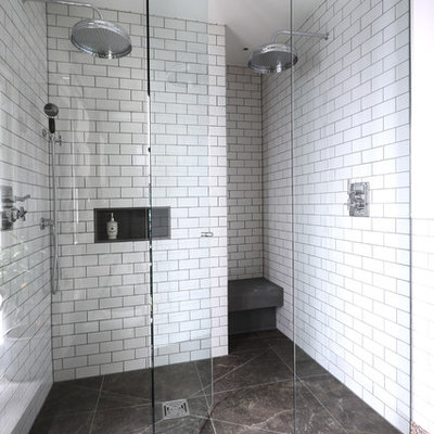 Bathroom - contemporary white tile and subway tile bathroom idea in London with white walls and a niche