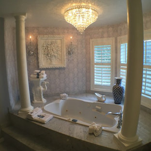 Large traditional master bathroom in Seattle with a hot tub, purple walls and marble floors.