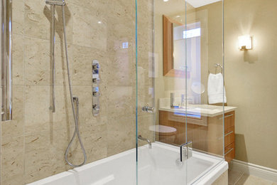 Example of a small trendy beige tile and porcelain tile porcelain tile bathroom design in Ottawa with flat-panel cabinets, medium tone wood cabinets, a wall-mount toilet, beige walls, an undermount sink and quartz countertops