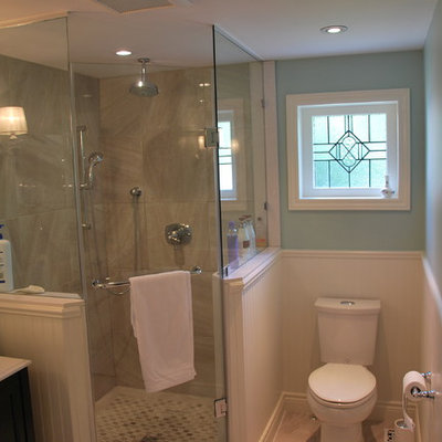 Corner shower - small traditional master beige tile and porcelain tile porcelain tile corner shower idea in Toronto with an undermount sink, furniture-like cabinets, dark wood cabinets, quartz countertops, a two-piece toilet and blue walls