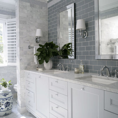 Bathroom - traditional gray tile bathroom idea in Raleigh with an undermount sink, recessed-panel cabinets and white cabinets