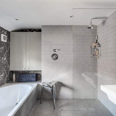Transitional master gray tile concrete floor bathroom photo in Oxfordshire with gray cabinets and gray walls