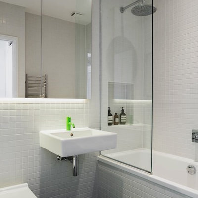 Inspiration for a small scandinavian white tile and ceramic tile cement tile floor and black floor bathroom remodel in London with white walls, a wall-mount sink and a wall-mount toilet
