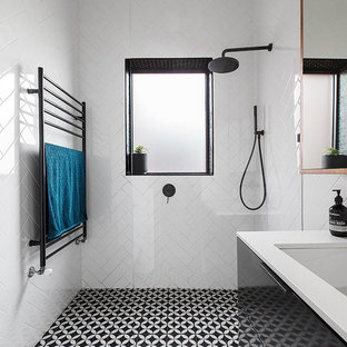 Design ideas for a contemporary 3/4 bathroom in Melbourne with flat-panel cabinets, black cabinets, a curbless shower, a one-piece toilet, white tile, porcelain tile, white walls, an undermount sink, an open shower and white benchtops.