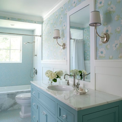 Mid-sized elegant blue tile and pebble tile pebble tile floor tub/shower combo photo in San Francisco with blue cabinets, an undermount tub, blue walls, marble countertops, an undermount sink, recessed-panel cabinets and white countertops