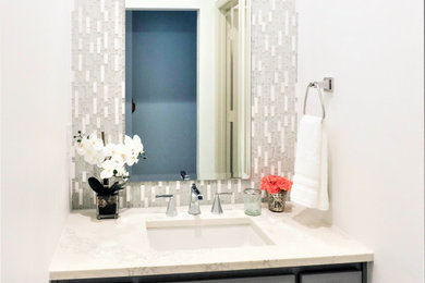 Mid-sized transitional kids' gray tile and mosaic tile marble floor and single-sink alcove shower photo in Dallas with gray cabinets, white walls, an undermount sink, quartz countertops, a hinged shower door, white countertops and a built-in vanity