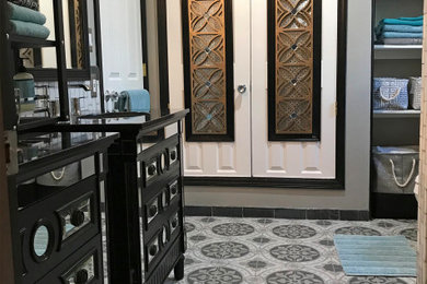 Example of a mid-sized minimalist black and white tile and marble tile porcelain tile and gray floor bathroom design in Albuquerque with glass-front cabinets, black cabinets, a two-piece toilet, gray walls, an undermount sink, granite countertops and black countertops