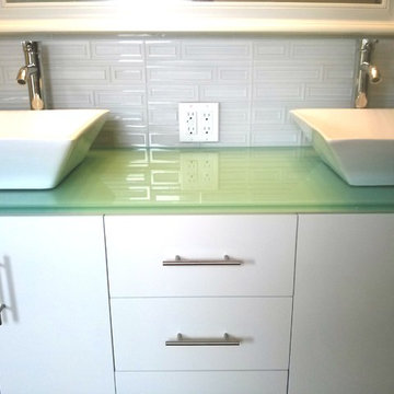 Glass backsplash compliments the clean design of the glass countertop