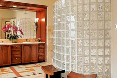 Example of a large classic master beige tile alcove shower design in Grand Rapids with raised-panel cabinets, medium tone wood cabinets and marble countertops