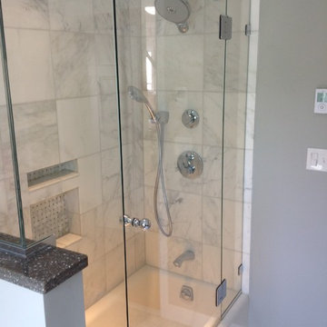 Glass Door Shower with White Marble Tile
