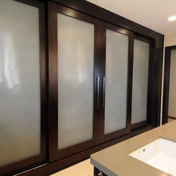 Glass Fronted Sliding Closet Doors in Modern Master Bathroom