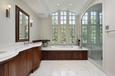 Large classic bathroom in Other with a built-in bath, white walls and white floors.