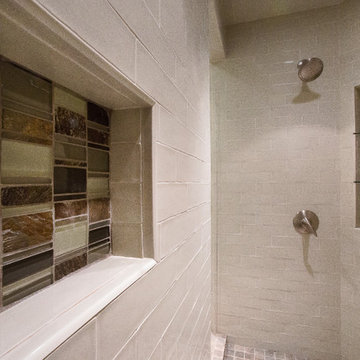 Glass tiles used to accent shower interior and vanity space