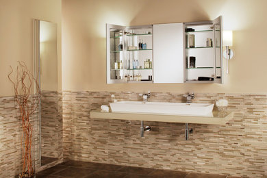 Large transitional master multicolored tile and glass tile ceramic tile bathroom photo in New York with a trough sink, glass countertops and beige walls