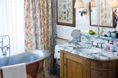 This is an example of a medium sized contemporary bathroom in Gloucestershire with white cabinets, a freestanding bath, grey walls, a built-in sink, marble worktops, a single sink and a built in vanity unit.