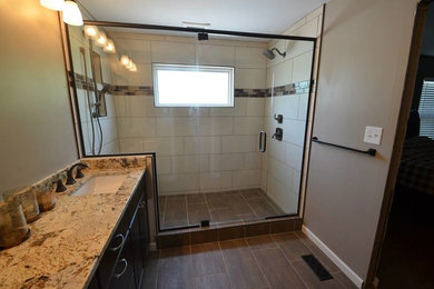 Example of a mid-sized classic master beige tile and ceramic tile ceramic tile alcove shower design in St Louis with an undermount sink, shaker cabinets, black cabinets, granite countertops, a one-piece toilet and beige walls