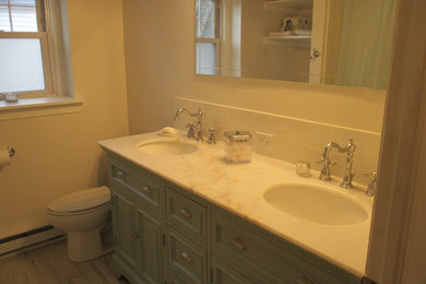 Bathroom - mid-sized contemporary master white tile and ceramic tile porcelain tile bathroom idea in Philadelphia with raised-panel cabinets, green cabinets, a two-piece toilet, white walls, an undermount sink and marble countertops