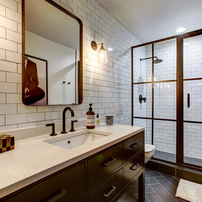 Mid-sized urban 3/4 white tile and subway tile porcelain tile and brown floor bathroom photo in Raleigh with furniture-like cabinets, black cabinets, a wall-mount toilet, white walls, an undermount sink, quartz countertops and white countertops