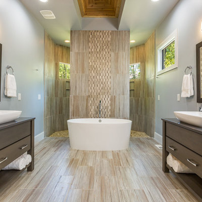 Inspiration for a transitional beige floor bathroom remodel in Raleigh with dark wood cabinets and flat-panel cabinets