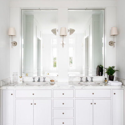 Elegant master white tile marble floor bathroom photo in Melbourne with an undermount sink, white cabinets, marble countertops, white walls and white countertops