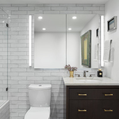 Tub/shower combo - mid-sized contemporary master white tile and ceramic tile marble floor and gray floor tub/shower combo idea in Chicago with flat-panel cabinets, dark wood cabinets, a two-piece toilet, white walls, an undermount sink, quartzite countertops, a hinged shower door and gray countertops