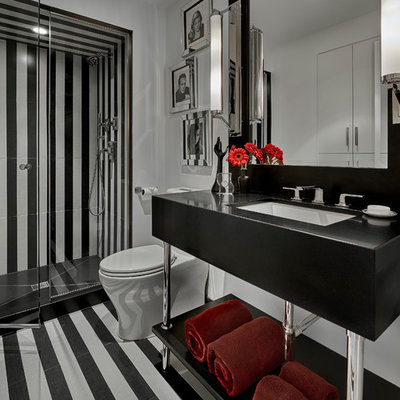 Alcove shower - mid-sized contemporary 3/4 black tile, black and white tile and white tile multicolored floor alcove shower idea in Chicago with open cabinets, a one-piece toilet, white walls, an undermount sink, a hinged shower door and black countertops