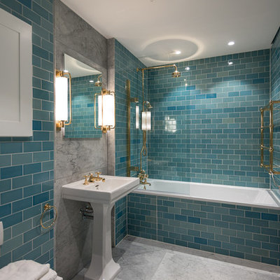 Example of a transitional master blue tile and subway tile bathroom design in London with blue walls and a pedestal sink