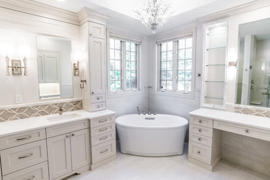 Bathroom - transitional master white tile and marble tile marble floor and white floor bathroom idea in Seattle with recessed-panel cabinets, white cabinets, a one-piece toilet, white walls, a drop-in sink, quartz countertops and a hinged shower door