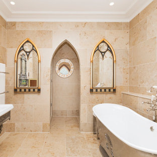 Photo of a medium sized mediterranean ensuite bathroom in Kent with a freestanding bath, a pedestal sink, beige tiles and beige floors.