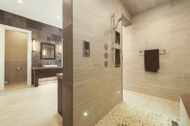Example of a large transitional master beige tile and porcelain tile porcelain tile and beige floor bathroom design in Toronto with flat-panel cabinets, dark wood cabinets, beige walls, a vessel sink and quartz countertops