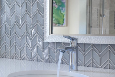 Example of a small beach style gray tile and glass tile porcelain tile bathroom design in San Diego with shaker cabinets, gray cabinets, a one-piece toilet, beige walls, an undermount sink and quartz countertops