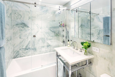 Inspiration for a mid-sized transitional 3/4 marble tile white floor bathroom remodel in New York with a one-piece toilet, a console sink, solid surface countertops and white countertops