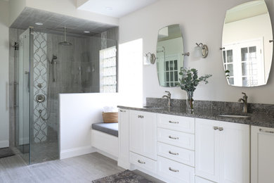 Inspiration for a mid-sized contemporary master gray tile and porcelain tile porcelain tile, gray floor and double-sink bathroom remodel in Jacksonville with shaker cabinets, white cabinets, a two-piece toilet, gray walls, an undermount sink, granite countertops, gray countertops, a niche and a built-in vanity